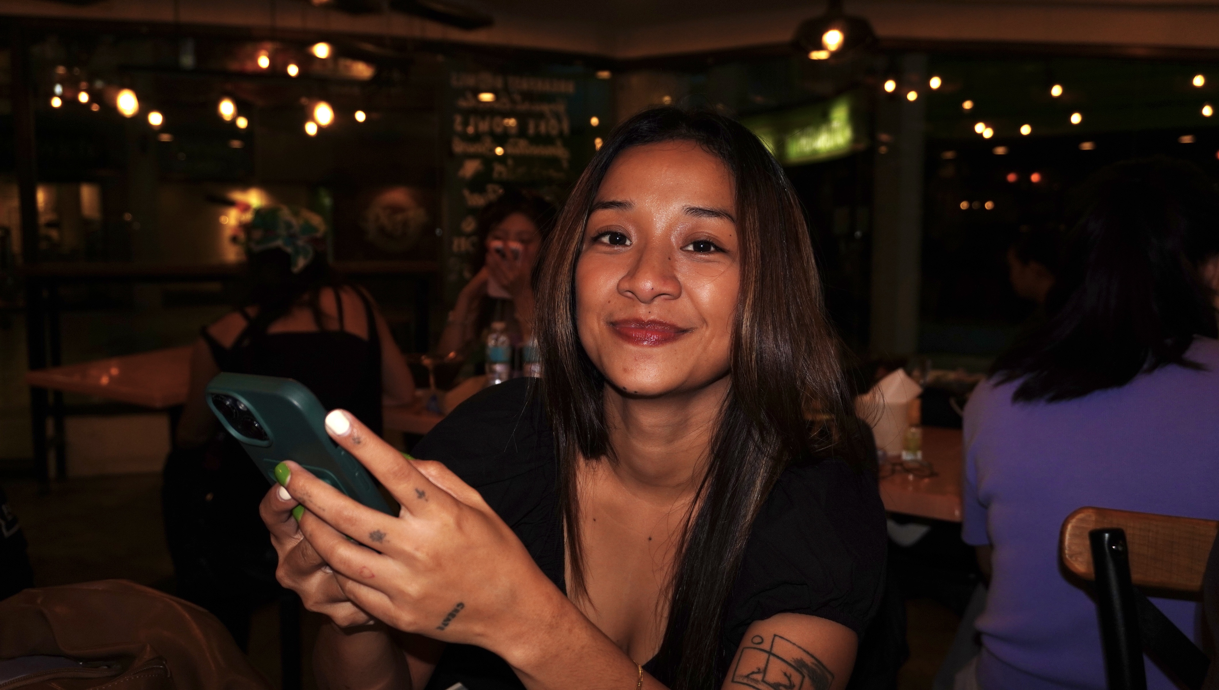 Ana Cameña smiling while holding her phone